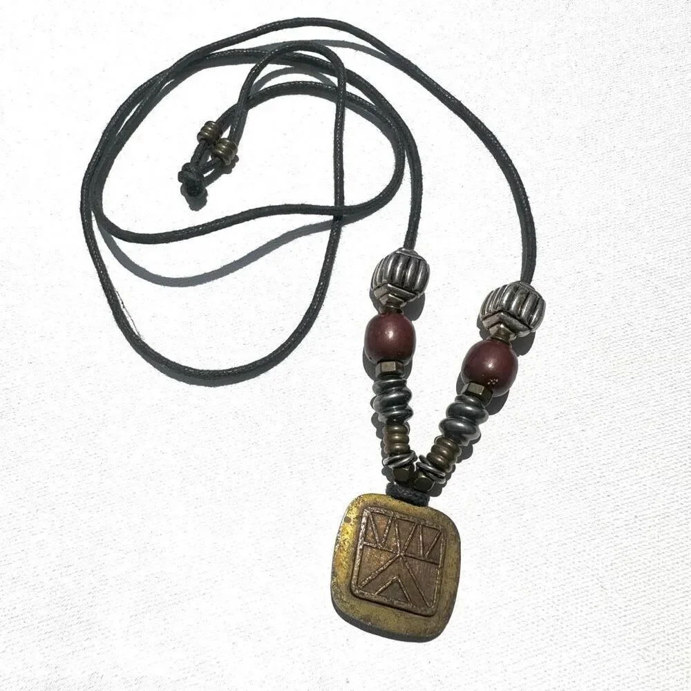 Baer SF sterling silver and brass pendant necklace on black cord